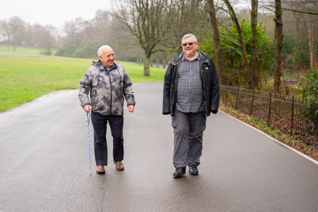Two adults walking together outdoors as part of community support